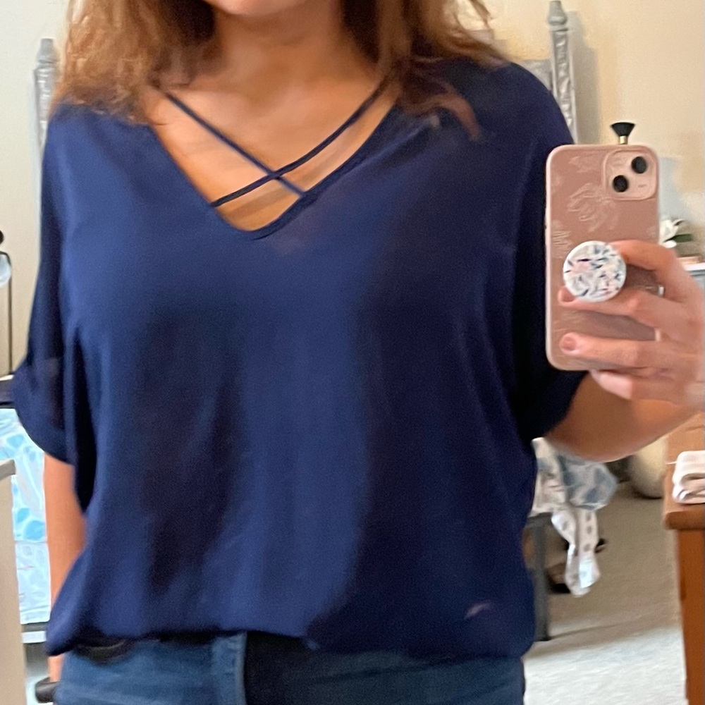Navy blue slub blouse with crossed-strip necklace.